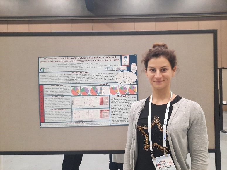dr Magdalena Marzec by the poster